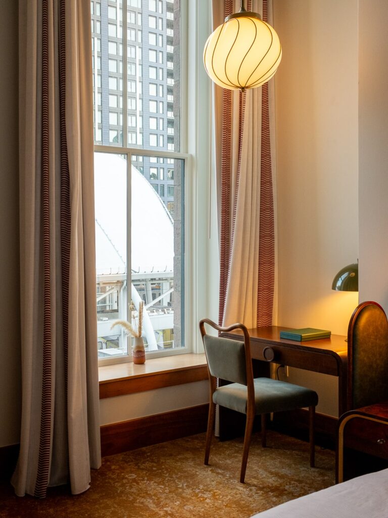 Desk by window inside room at Crawford Hotel